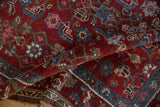 Folded vintage Kurdish Hamadan rug, black cherry red geometric field, blue floral border.