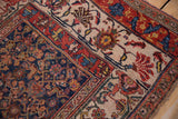 Antique Bijar rug's navy blue main field with intricate, multicolored Herati pattern.
