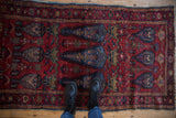 Deep raspberry red and denim blue shrub design on a vintage Lilihan runner, shown with boots.