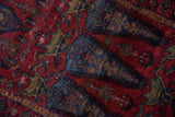 Saturated raspberry, denim blue, emerald Lilihan rug pile with shrub blossoms.