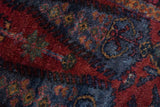 Matted pile texture of a vintage Lilihan rug with saturated gem-tone red and blue.