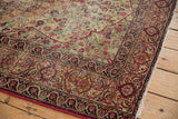 Dark navy blue border and cochineal red floral motifs on antique Persian Kerman rug.