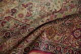 Antique Kerman rug's cochineal red, navy, dusty gold floral border, with visible side selvage.