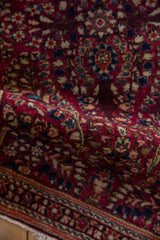 A gentle wave in the fine American Sarouk rug highlights its dense, even pile and delicate floral details.