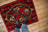 Vintage Karabagh rug shown underfoot to feature its true scale and bold floral medallion design.