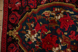 Hidden bird and serpent motifs in cherry red and teal on a vintage Armenian Karabagh rug.