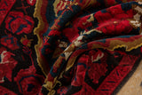 Textural detail of the vintage Karabagh rug's soft pile in black cherry red and teal.
