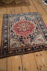 Antique Farahan Sarouk corner, showing delicate vinery, navy border, and worn pile.