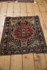 Antique Farahan Sarouk rug corner, showcasing fine vinery on navy border and aged edge.