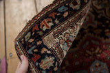 Rewoven area detail on the antique Farahan Sarouk rug's traditional border.