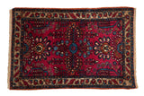 Vintage Lilihan rug with raspberry red floral sprays, sapphire blue accents, and a beige border.