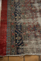 Reciprocating pawn motif border and cherry red stripe showing threadbare wear on an antique Serab.