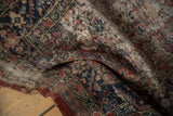 Worn pile and reciprocating pawn motif on the folded corner of an antique Persian Serab rug.