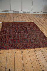 Tattered fringe on a vintage Ersari rug showing chestnut and navy blossom guls.