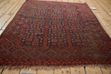 Vintage Ersari square rug with chestnut, indigo blossom guls, noticeable knot head wear, and tattered ends.