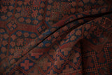 Vintage Ersari rug texture with chestnut, indigo blue, and dusty blush blossom guls.