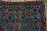 Detail of vintage Lilihan rug: sky blue, raspberry red Veramin lattice design.