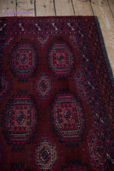 Burgundy, fuchsia, and navy guls with a stylized floral border on the vintage Turkmen rug.