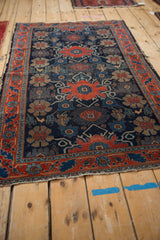Intricate floral top views and delicate vinery on a worn antique Senneh rug.
