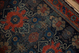 Antique Senneh rug: Rare floral patterns, vinery on navy field, displaying pile wear.