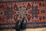 Detailed vintage Lilihan rug section: dusty blush field, sapphire blue, and brown floral motifs.