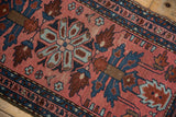 Vintage Lilihan rug's central medallion, oversized simplistic palmettes in dusty blush and sapphire blue.