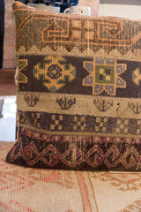Vintage rug fragment pillow detail, with deep plum, brown, and beige geometric patterns.