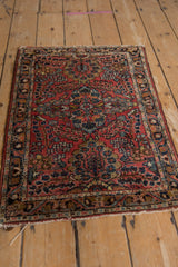 Vintage Lilihan rug's intricate border, featuring brick red, navy, and gold Sarouk floral motifs.