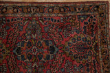 Vintage Lilihan rug detail: classic Sarouk-style floral pattern in brick red, navy, and gold.