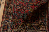 Lilihan rug pile texture with brick red, blue, and bronze Sarouk style floral patterns.