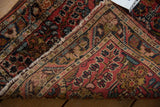 Intricate floral pile, original side cord selvage, and tattered fringe of this vintage Lilihan mat.