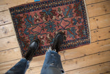 Vintage Mehriban rug corner, dusty raspberry field, blue floral vinery, narrow border, and fringe.