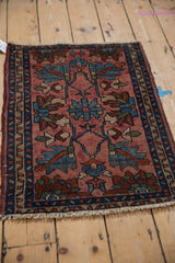 Vintage Mehriban rug: dusty raspberry field, sky blue florals, dark blue vine border, fringe.