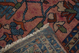 Hand-knotted foundation, fringed edge, and raspberry, blue pile of the vintage Mehriban rug.