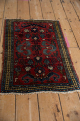Close-up of vintage Borchalou rug featuring cherry red field, navy cloudband motifs, and a patterned border.