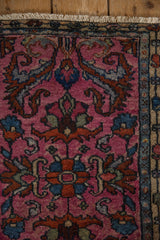 Corner of a vintage Borchalou rug with a fuchsia pile, detailed boteh border, and short fringe.