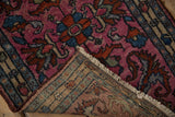 Folded corner of a fine Persian Borchalou rug revealing its hand-knotted back and short fringe.