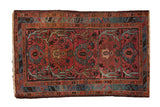 Vintage Mehriban rug with dusty raspberry palmettes, expressive vines, and blue serpent border.