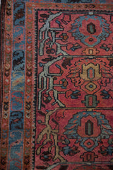 Vintage Mehriban rug's intricate blue serpent stylized main border with dusty raspberry field.