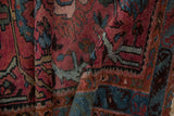 Hand knotted Mehriban rug with dusty raspberry, indigo blue scrolled vine detail.