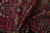 Raspberry red Lilihan rug showcasing scrolled leaves, floral bouquets, and visible knotting.