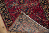 View of the hand-knotted Lilihan rug's woven foundation, fringe, and floral details.