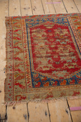 Vintage Anatolian rug with worn red field, revealing foundation and sapphire blue border.