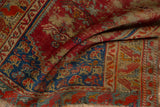 Blossomed corner spandrel of vintage Anatolian rug; cherry red and sapphire blue with wear across knot heads.