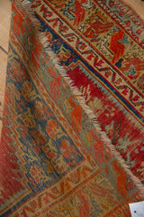 Folded vintage Anatolian rug detail, revealing textured pile, areas of wear, cherry red, sapphire blue motifs.