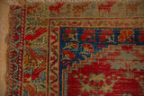Anatolian rug corner, with visible foundation wear, cherry red blossomed spandrel details.