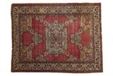 Antique Fine Doroksh rug, dramatic medallion, palmettes, and detailed vine border on cochineal red.