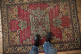 Antique Doroksh rug: striking blue-green medallion, palmettes, and softened cochineal red field.