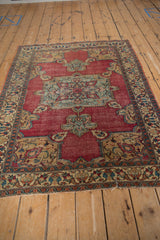 Antique Doroksh rug's dramatic central medallion featuring blue, blush palmettes with a soft patina.