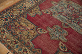 Antique Doroksh rug corner detail: blue spandrel, meandering vine border, time-softened cochineal field.